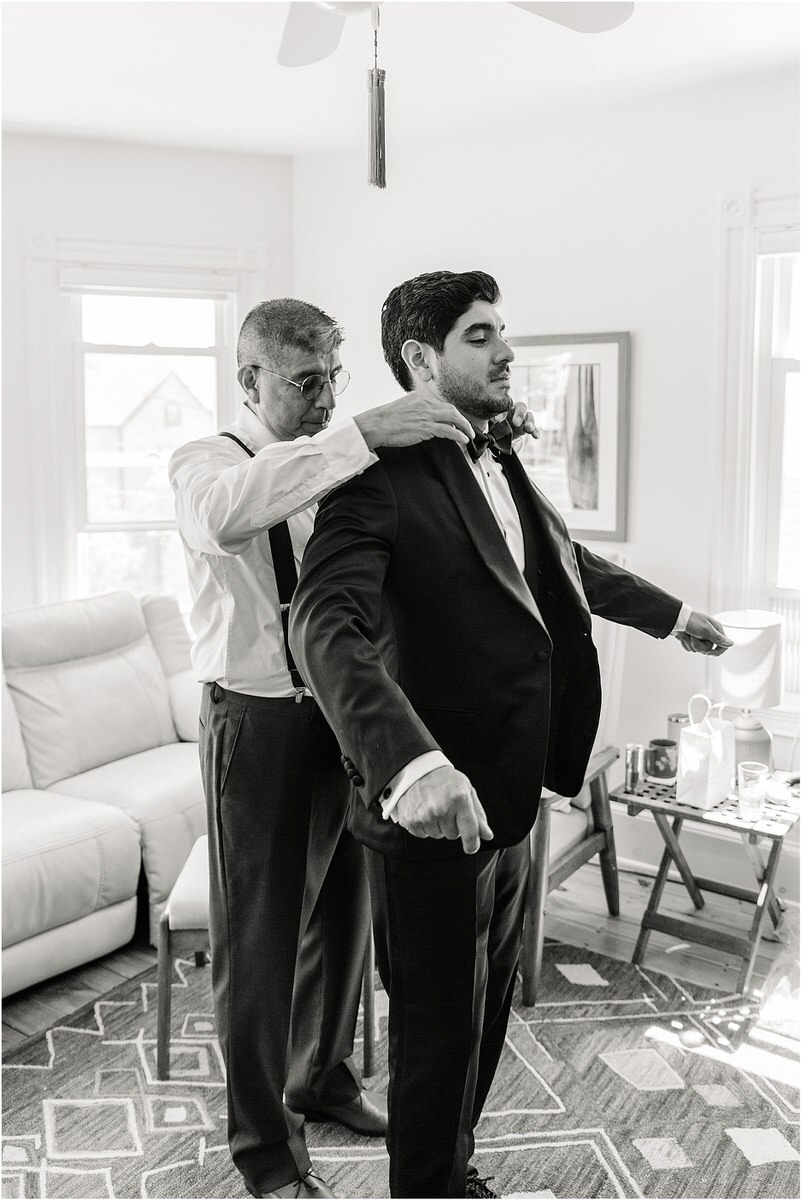 Family helps groom into suit and tie for Maine Coastal Wedding