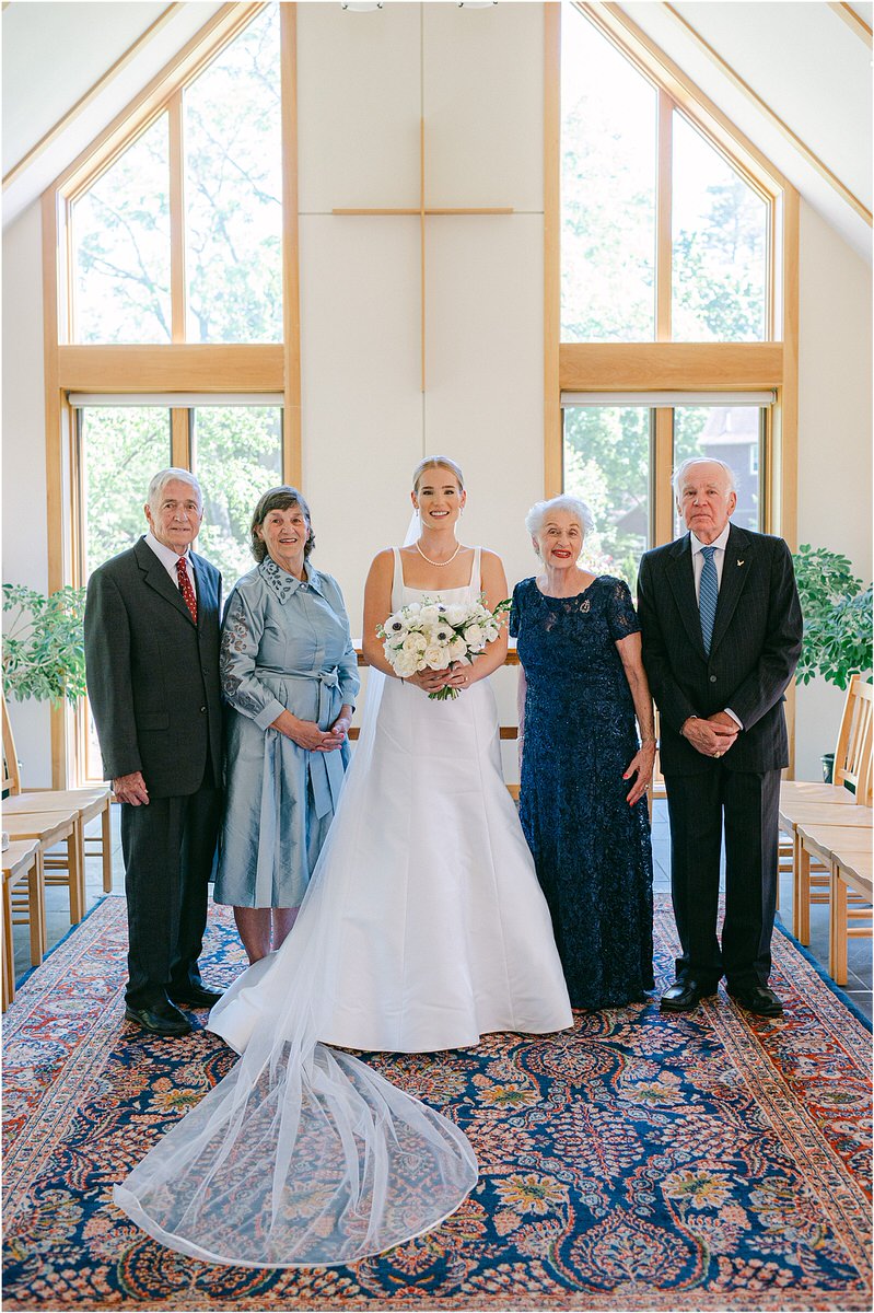 Bride stands with family for Maine Coastal Wedding