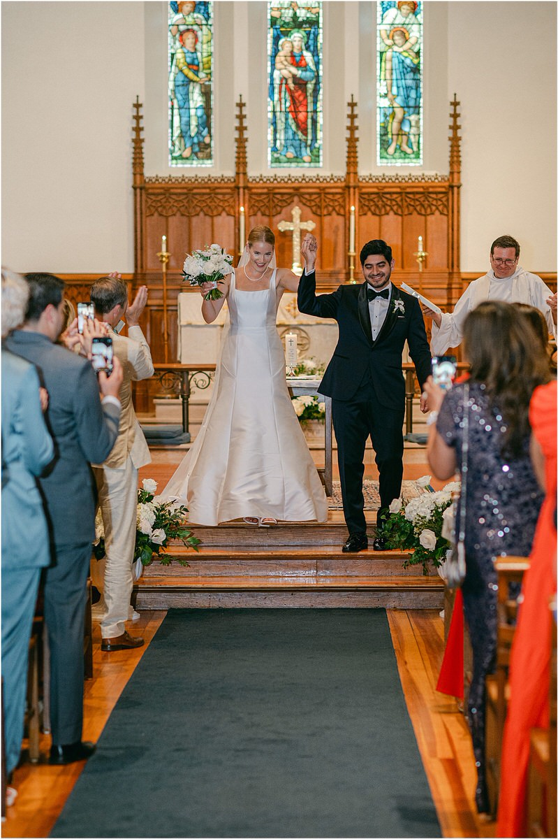 Bride and groom walk down church steps for Maine Coastal Wedding