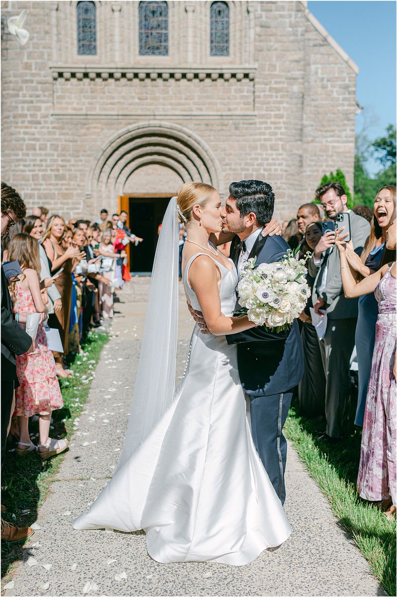 Couple share a kiss at Maine Coastal Wedding