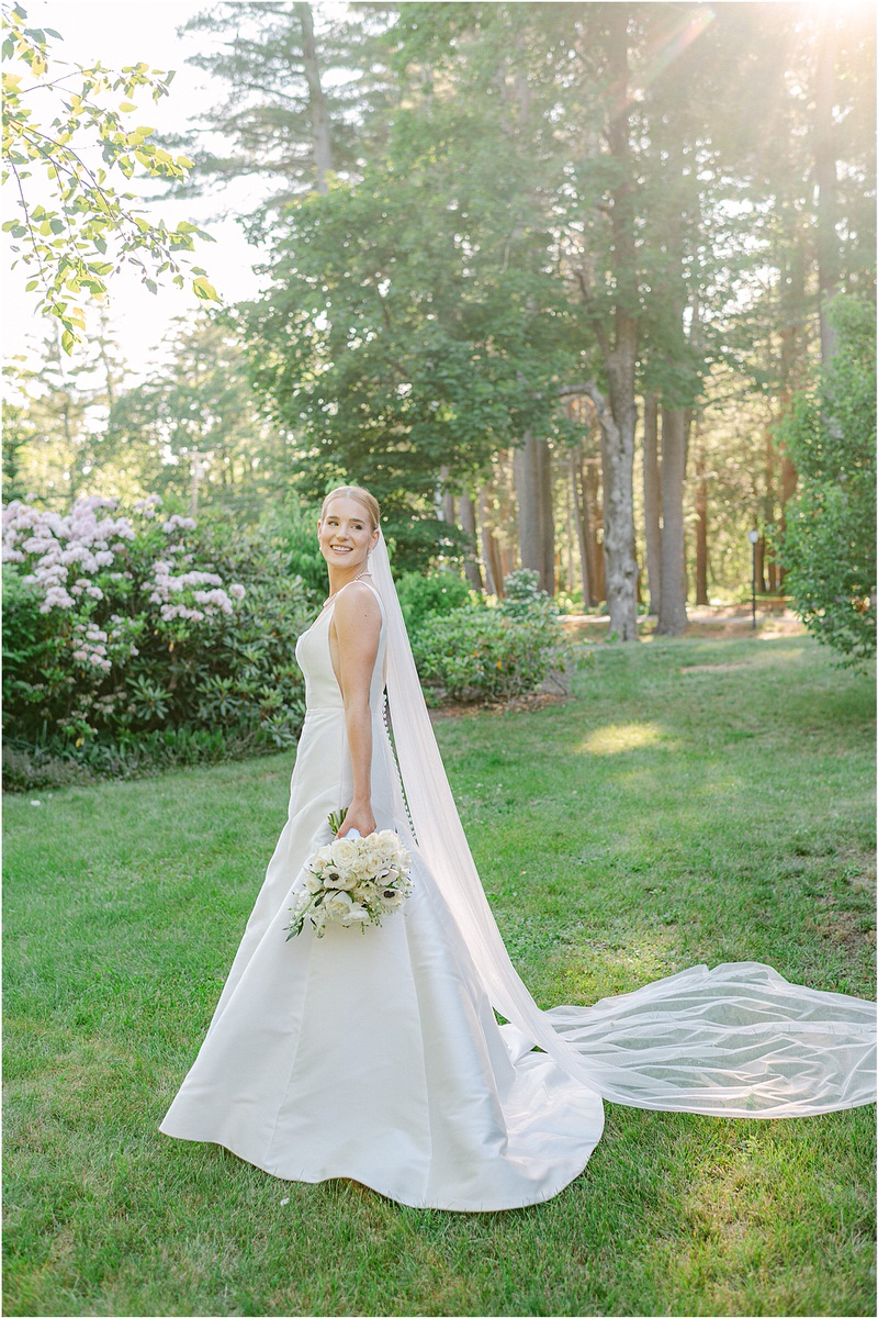Bride looks over her shoulder wearing a gorgeous gown for Rachel Campbell Photography
