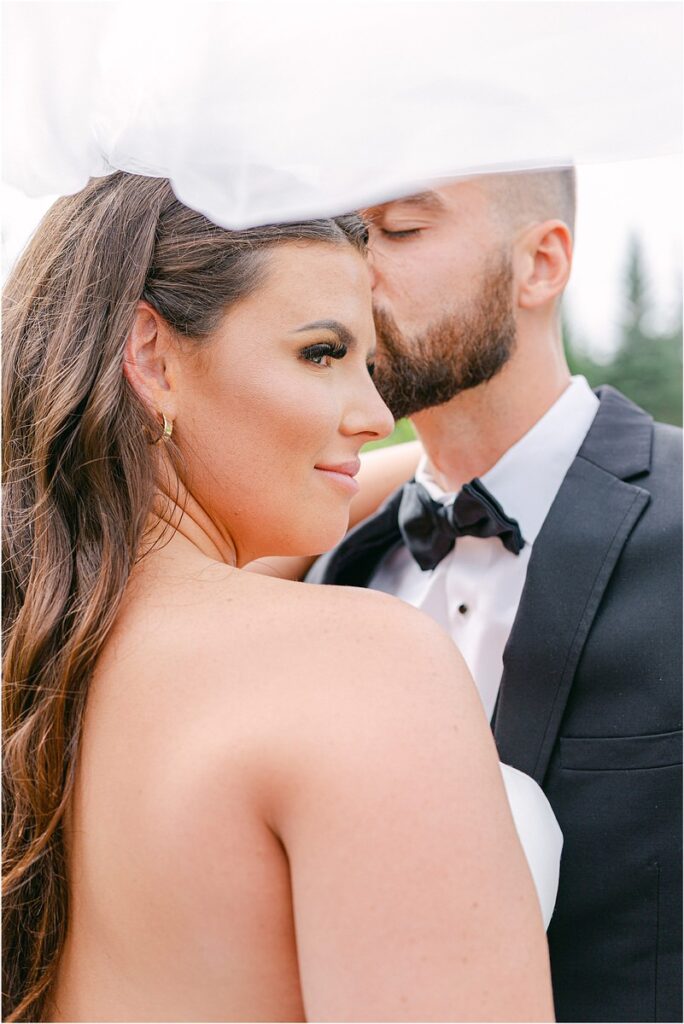 Man kisses woman on head for Owls Head, ME Wedding 