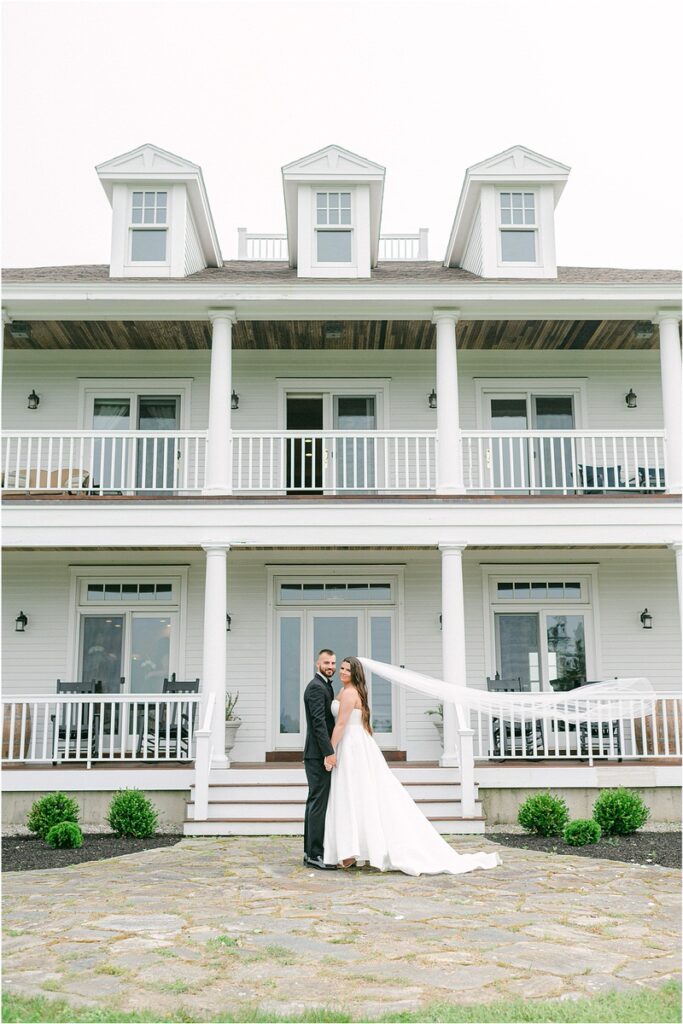 Bride and groom stand in front of venue for Summer Maine Wedding