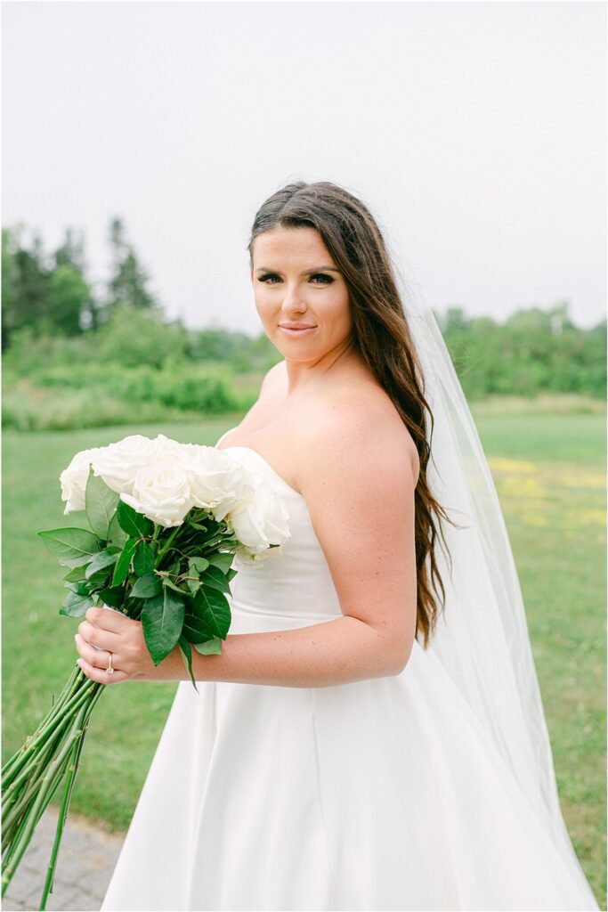Bride holds bouquet for Summer Maine Wedding