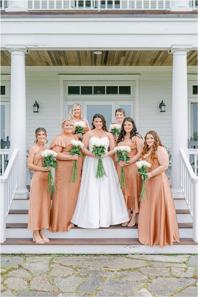 Bride is surrounded by bridesmaids for Summer Maine Wedding