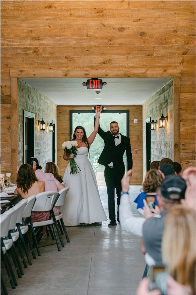 Bride and groom enter reception area for Maine Barn Wedding