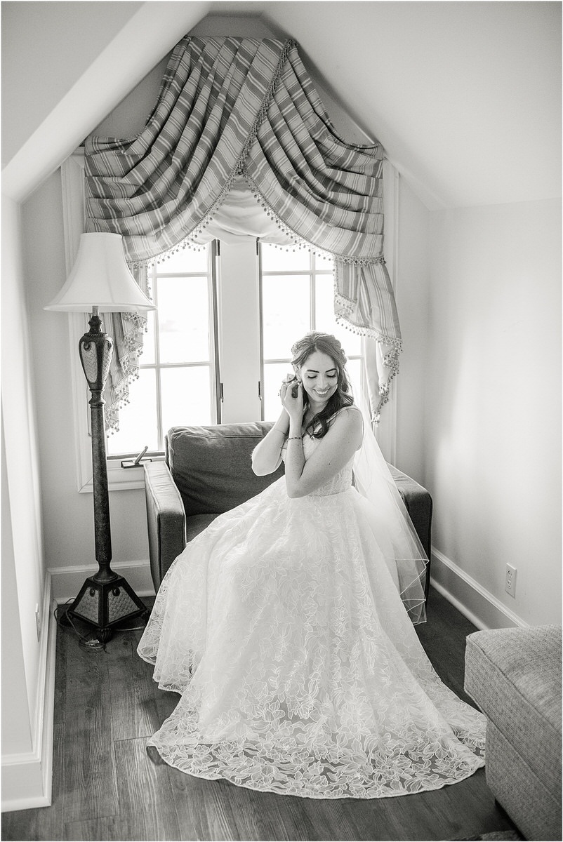 Bride adjusts wedding jewelry for wedding at Bar Harbor Club