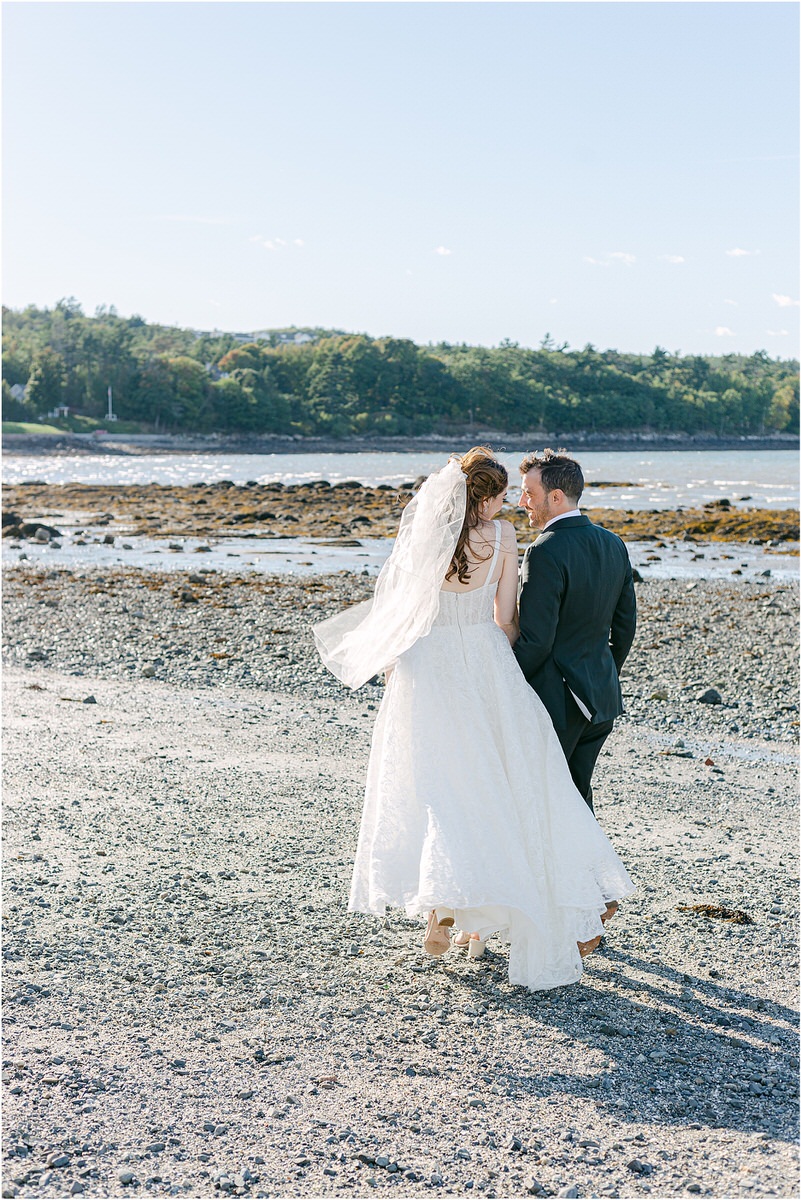 Couple walk hand in hand at Bar Harbor Club