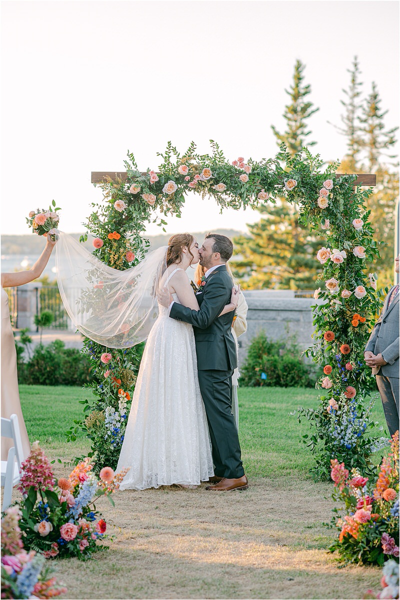Husband and wife share their first kiss during Maine Fall Wedding