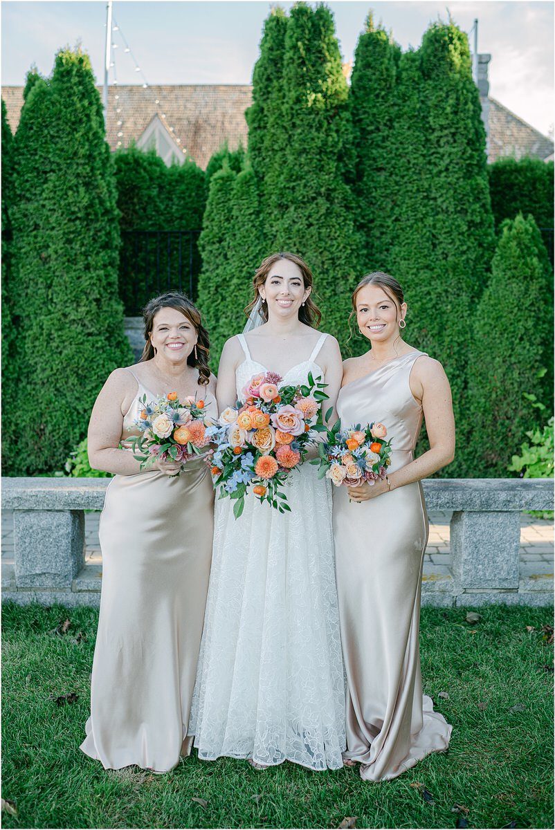 Bride stand with bridesmaids for Maine Fall Wedding