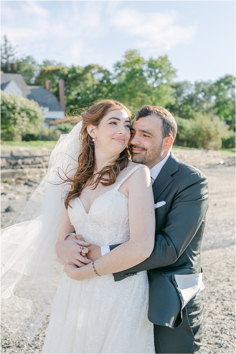husband and wife hold one another close together for Maine Fall Wedding