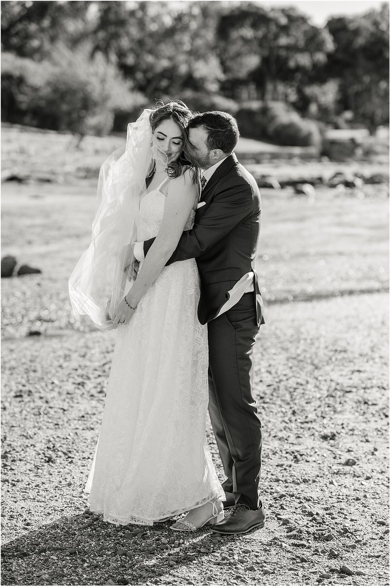 Man and woman cuddle in close together for Maine Fall Wedding