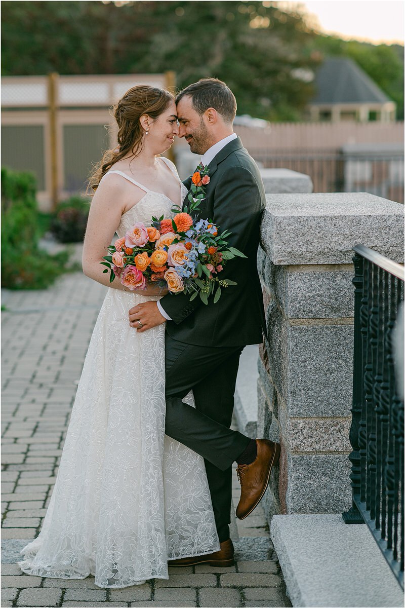 Bride and groom cuddle in close together for Maine Fall Wedding