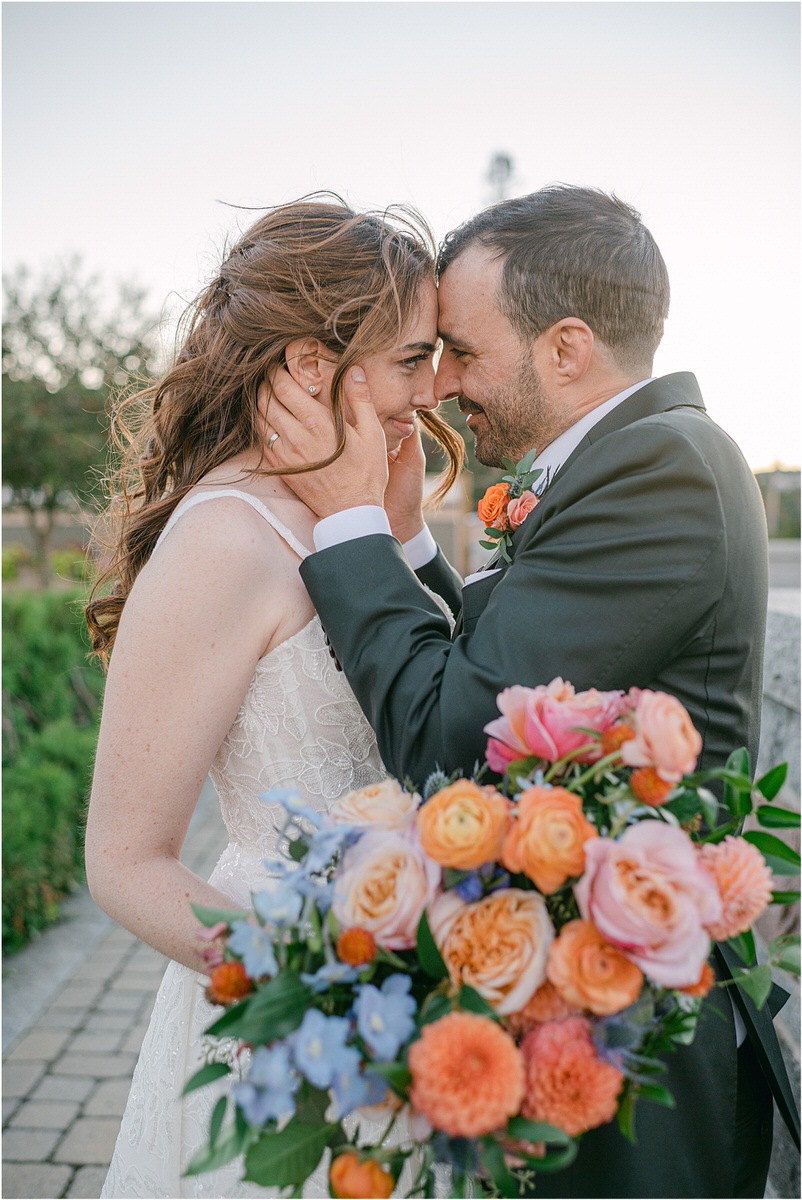 Bride and groom cuddle in close together for Maine Fall Wedding