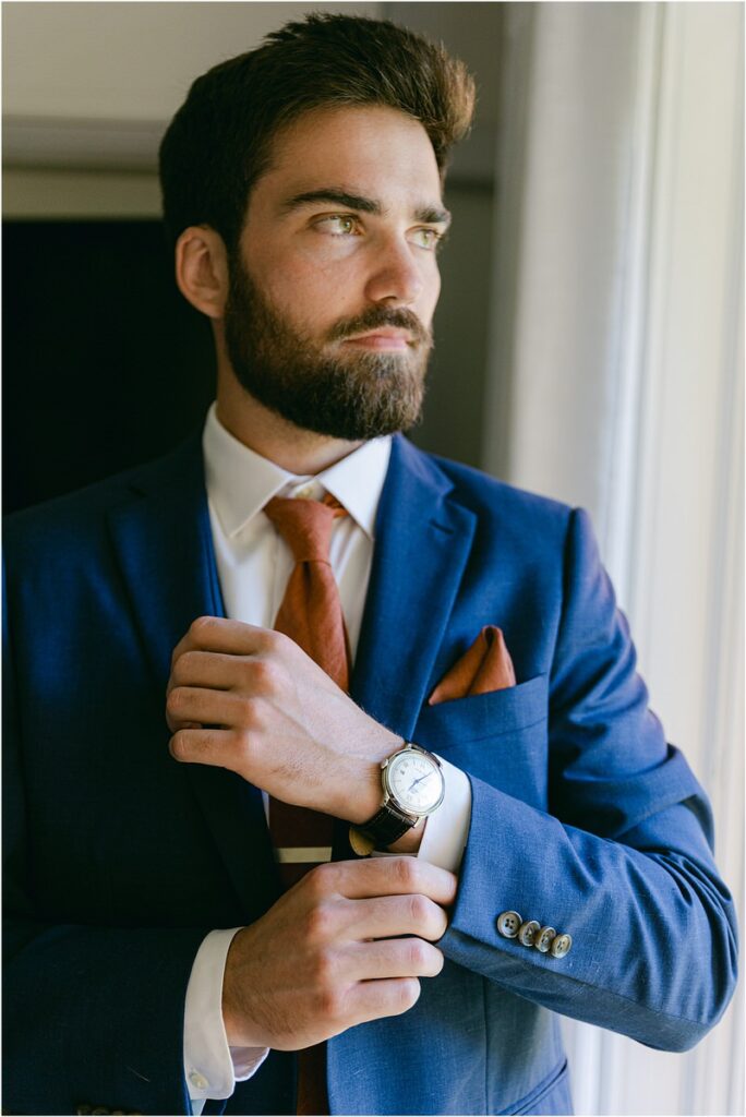 Groom adjusts watch at Beech Ridge Barn