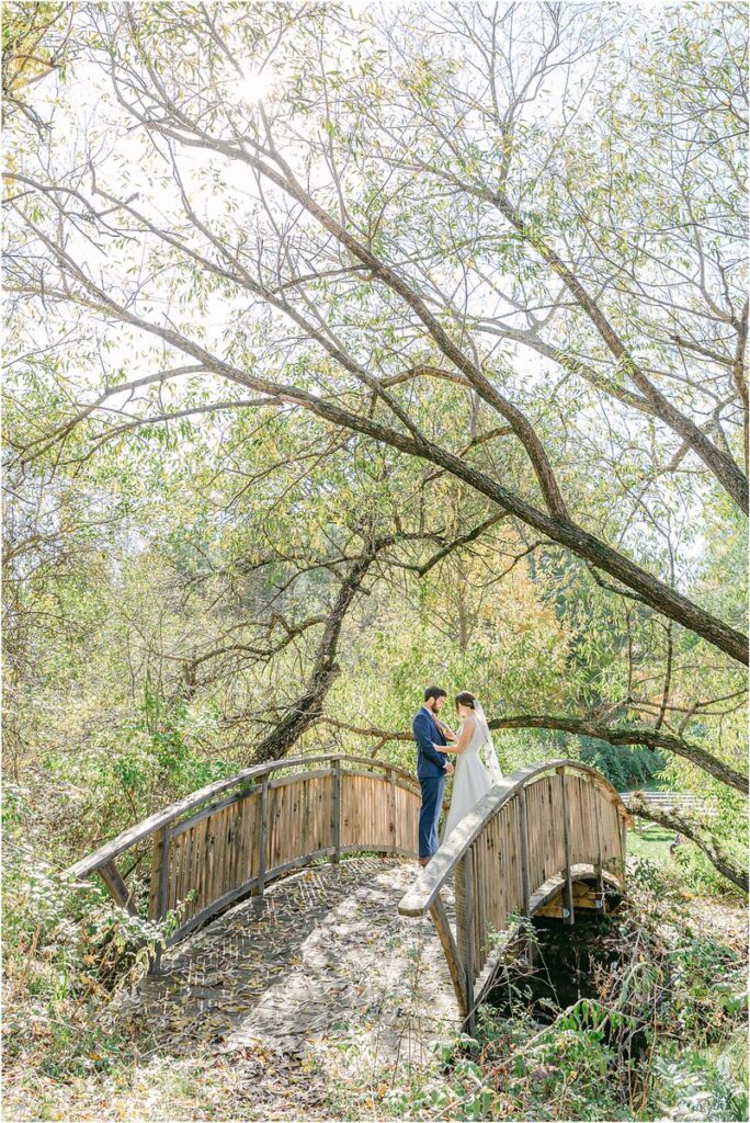 Bride and groom stand together at Beech Ridge Barn