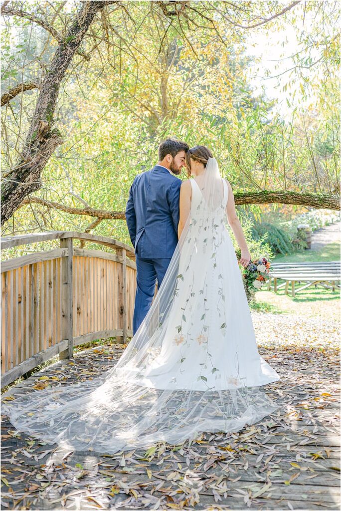 Bride and groom stand close together at Beech Ridge Barn