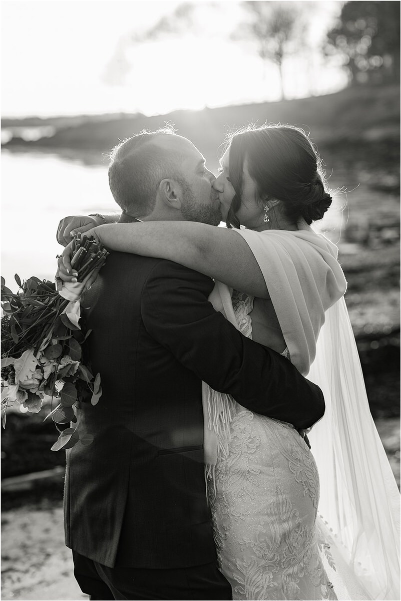 Man and woman share a kiss by Rachel Campbell Photography