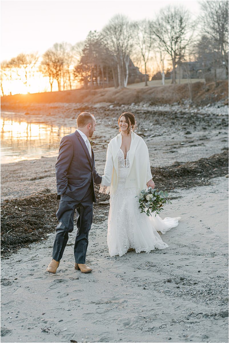 Couple walk together near the water by Rachel Campbell Photography
