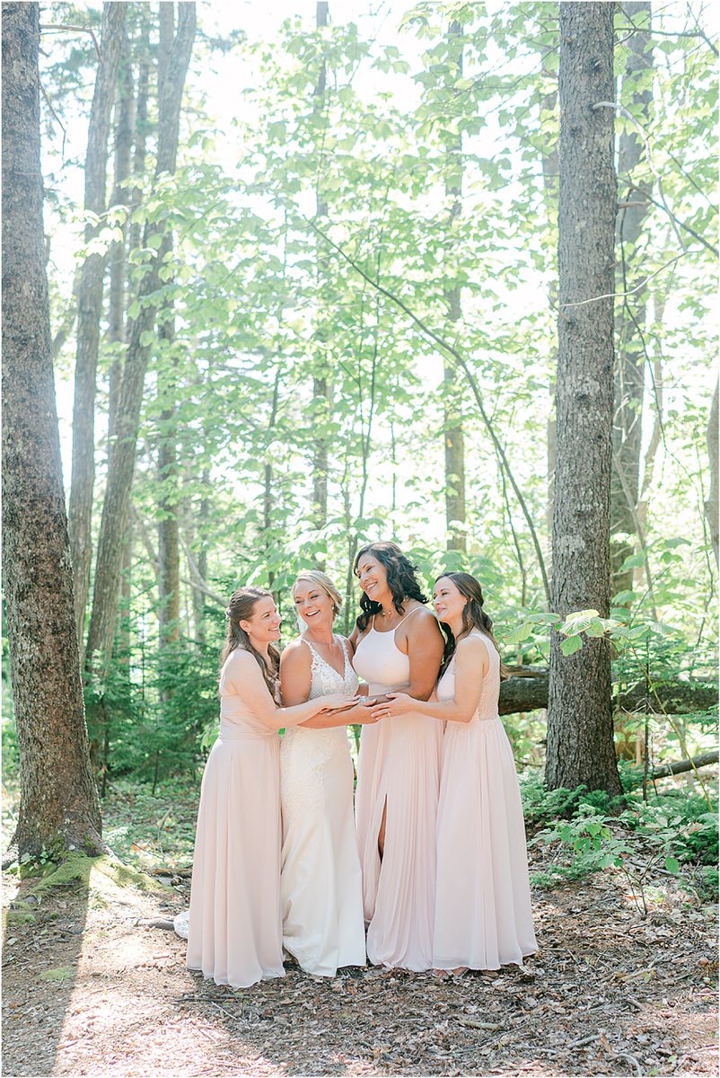 Bride stands with bridesmaids at Spruce Point Inn