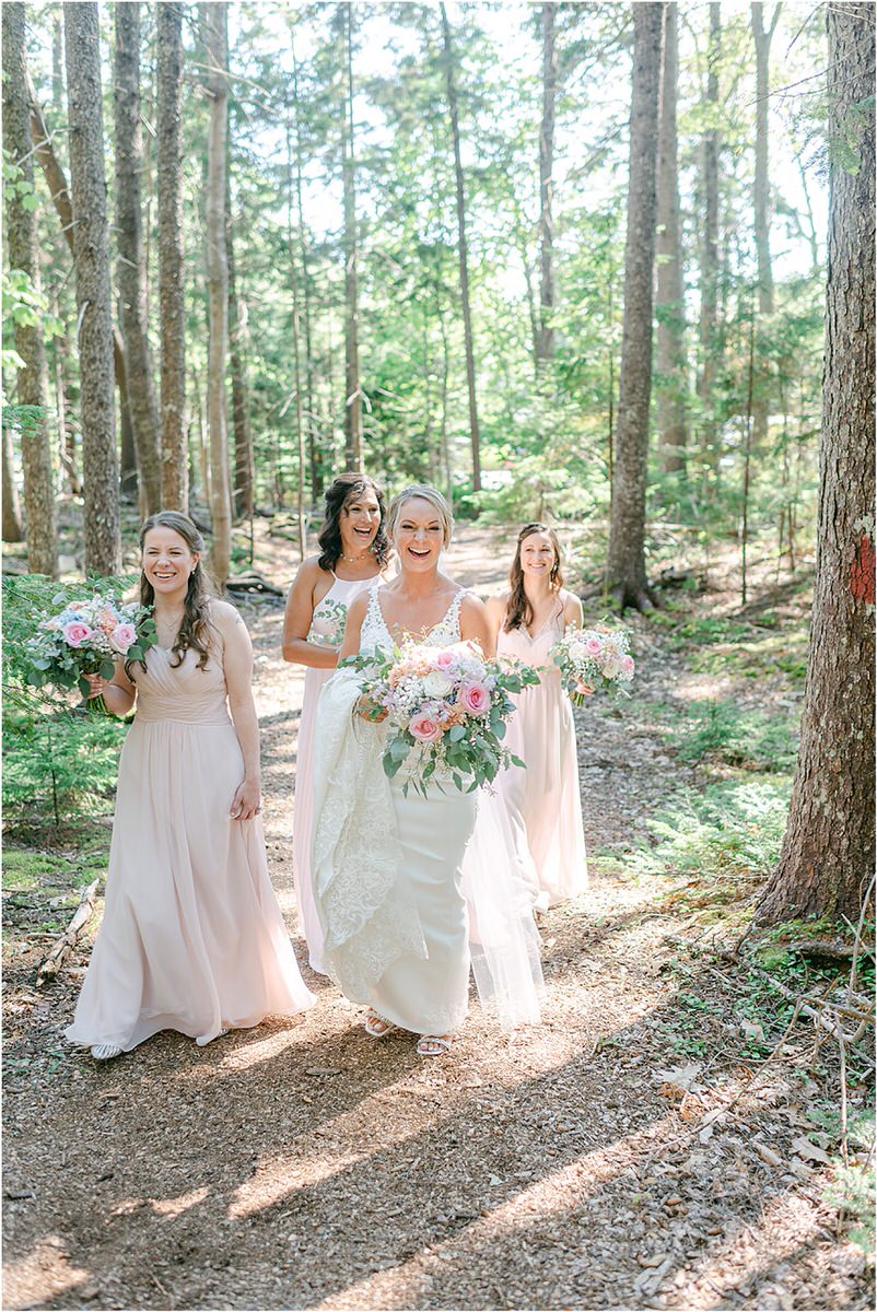 Bride walks with bridesmaids at Spruce Point Inn
