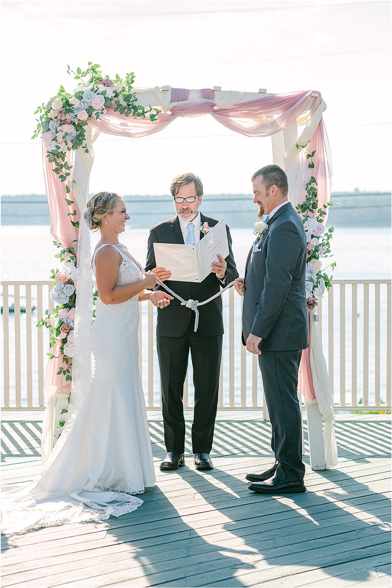 Couple stand altar at Spruce Point Inn
