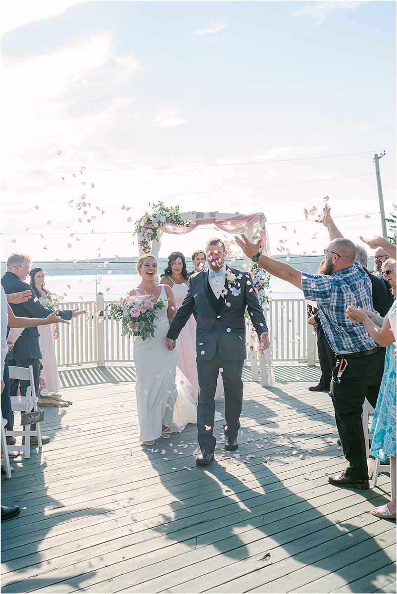Couple walk down the aisle at Spruce Point Inn
