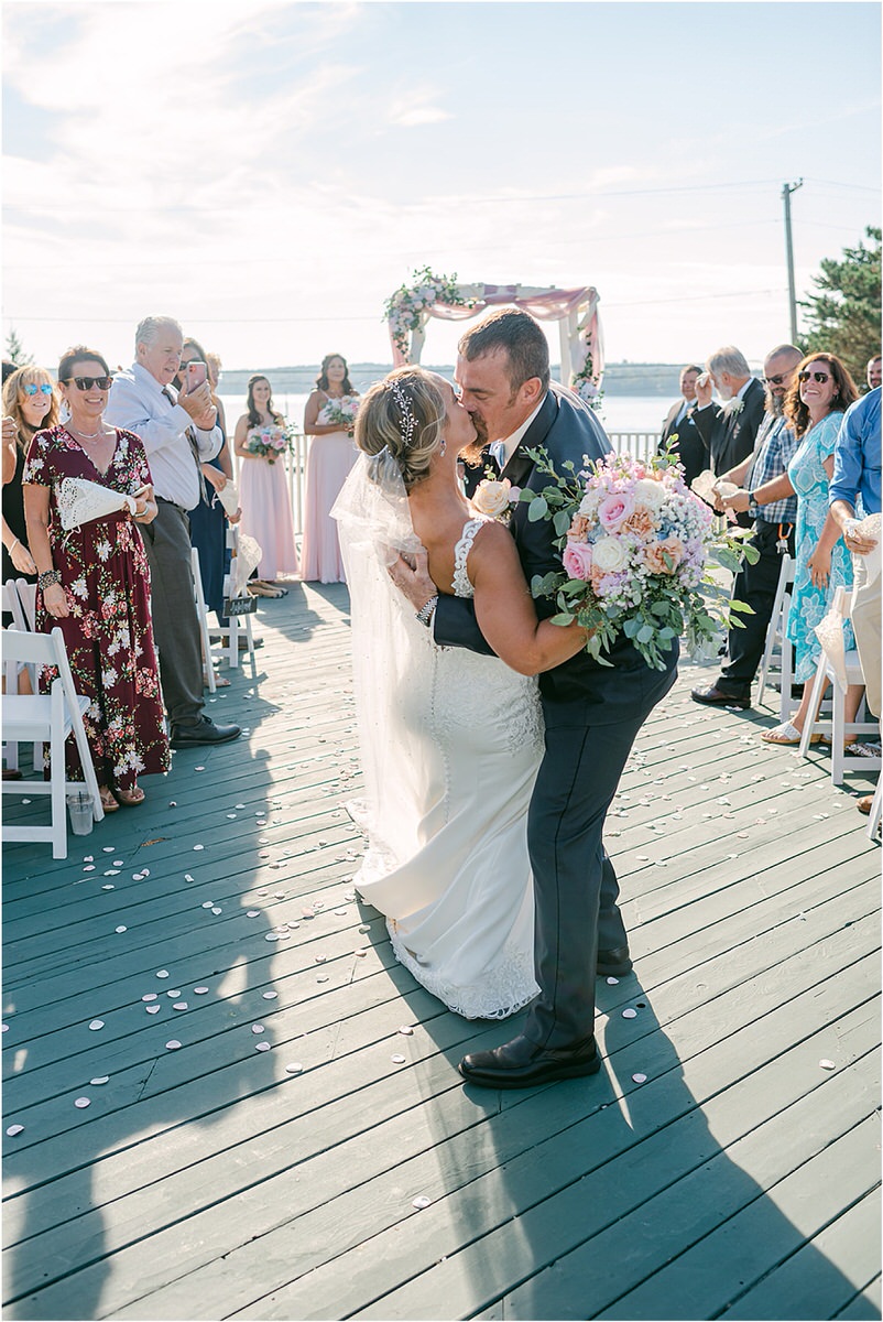 Husband and wife share a kiss at Spruce Point Inn