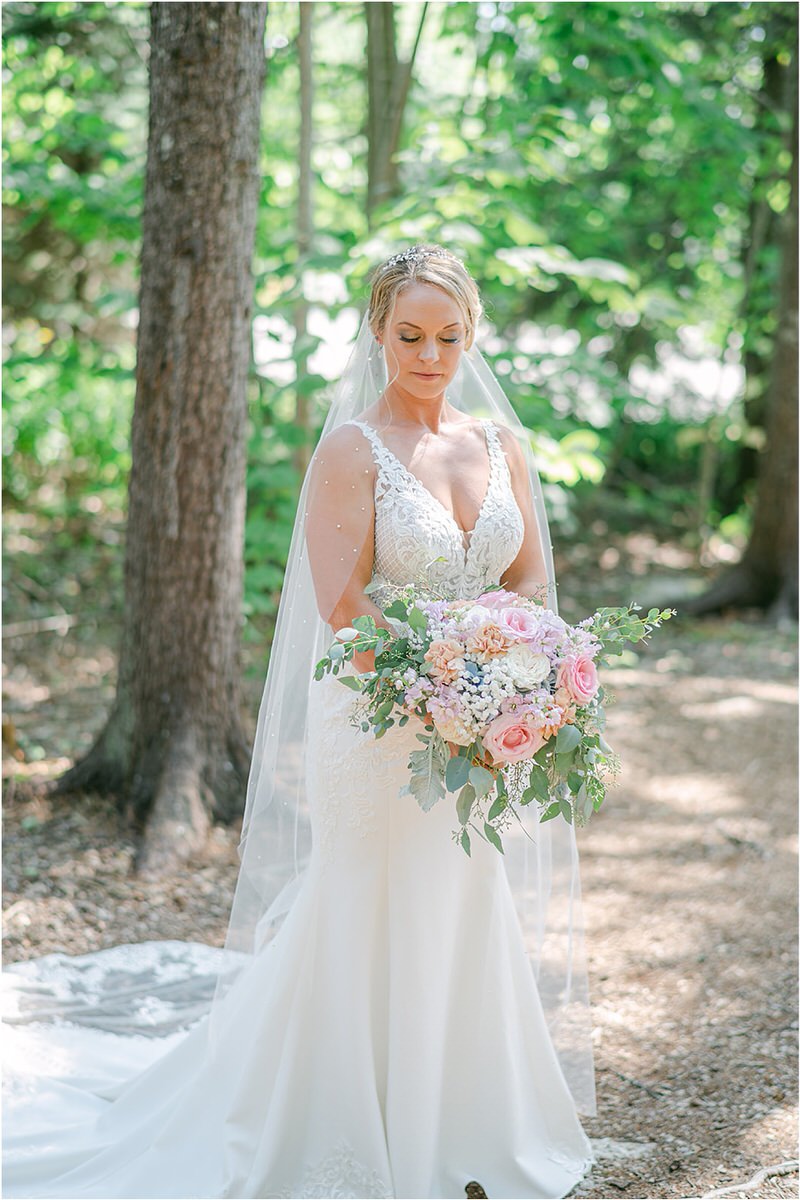Bride holds wedding bouquet at Spruce Point Inn