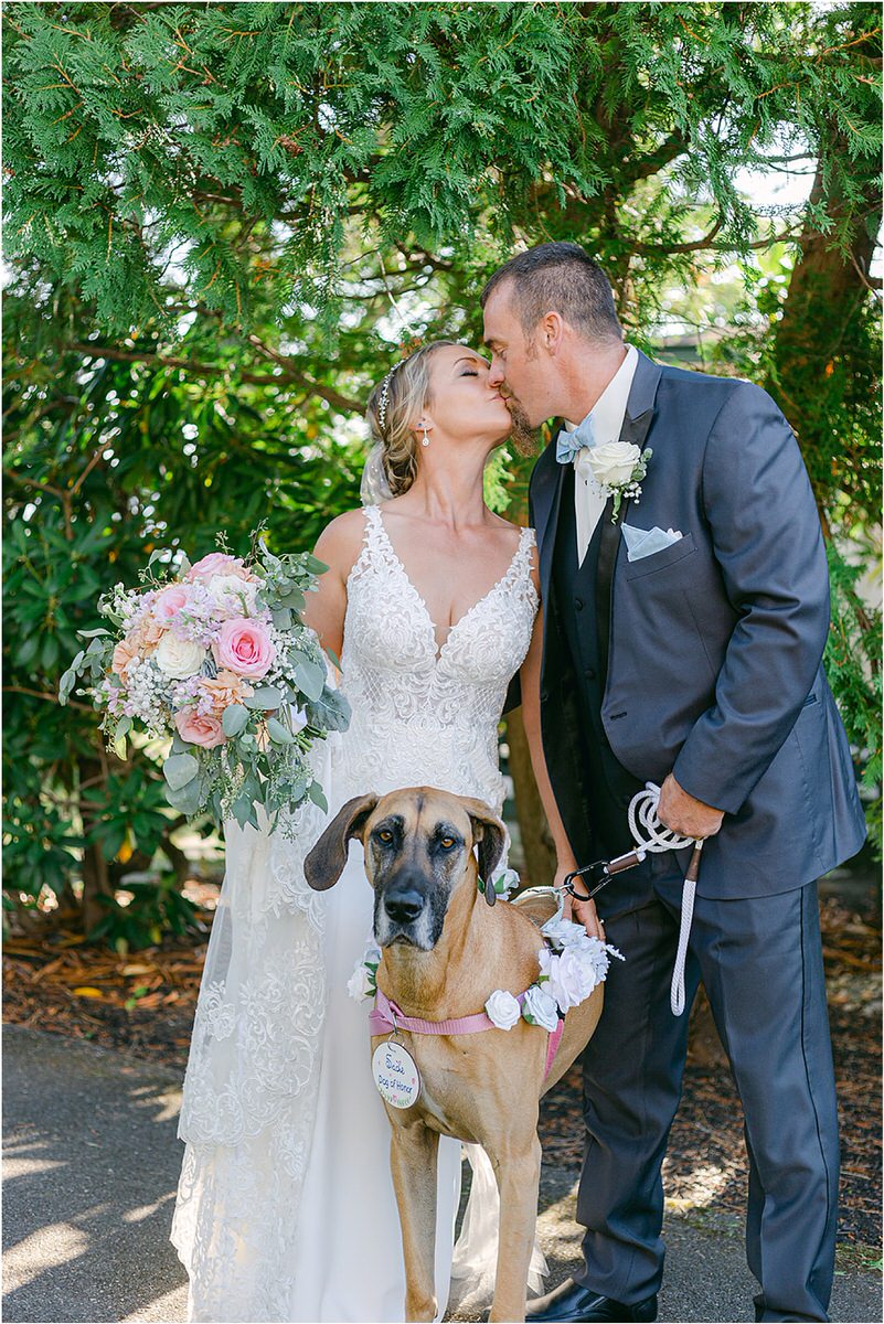 Husband and wife hold their dog for Rachel Campbell Photography
