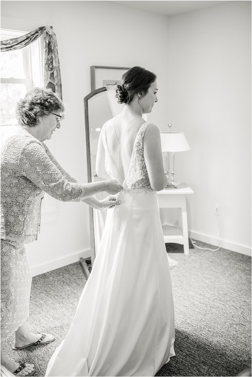 Bride gets into bridal gown for wedding at The 1812 Farm