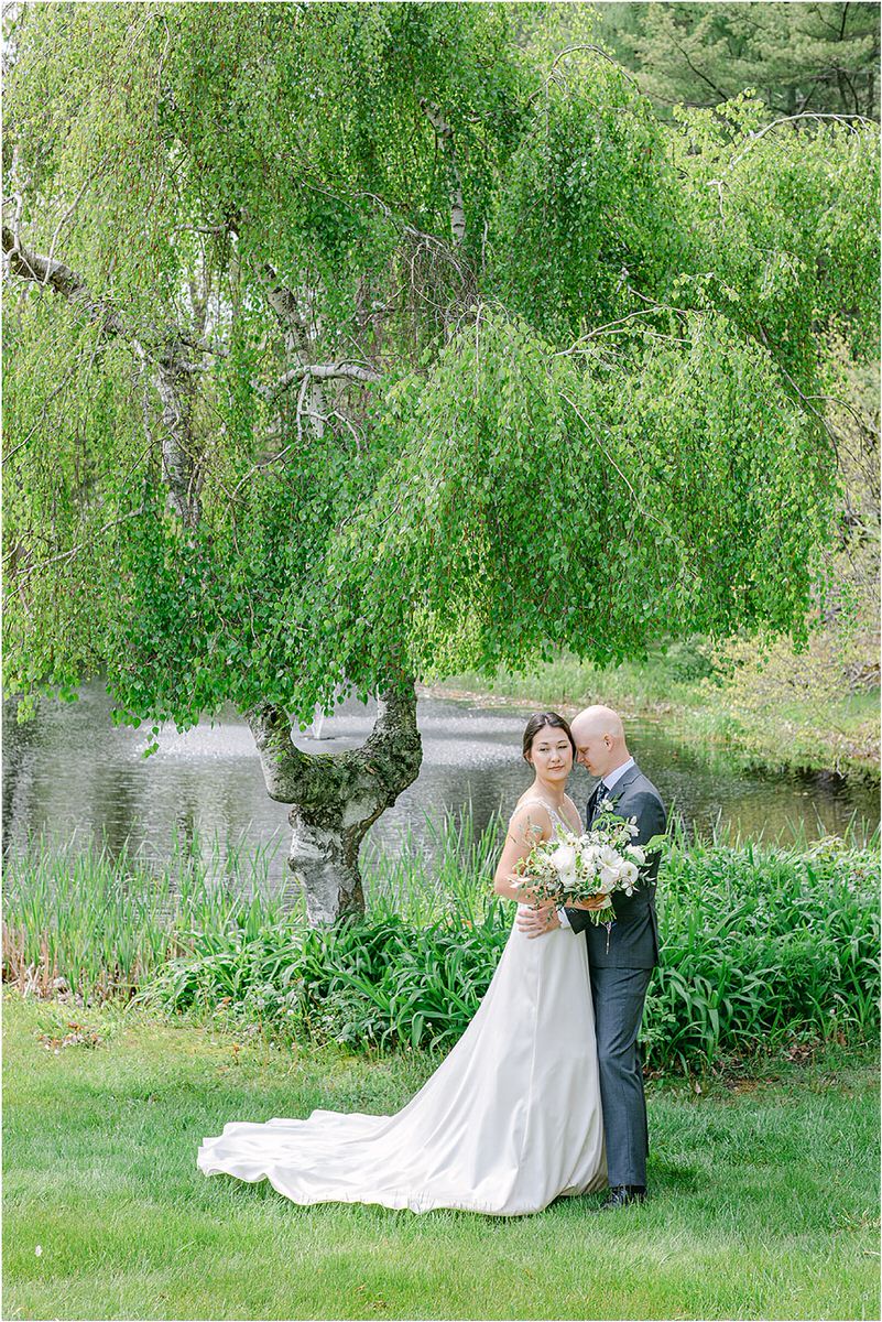 Couple stand close together for wedding at The 1812 Farm