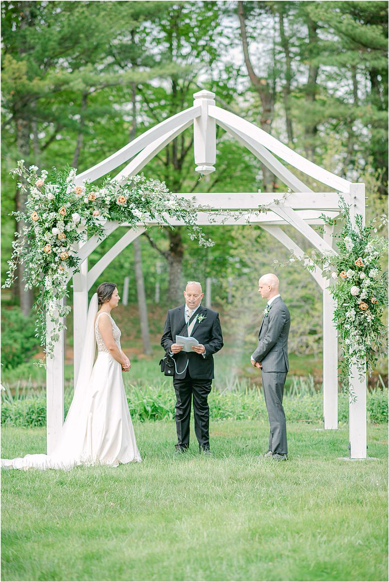 Bride and groom stand at wedding altar for wedding at The 1812 Farm