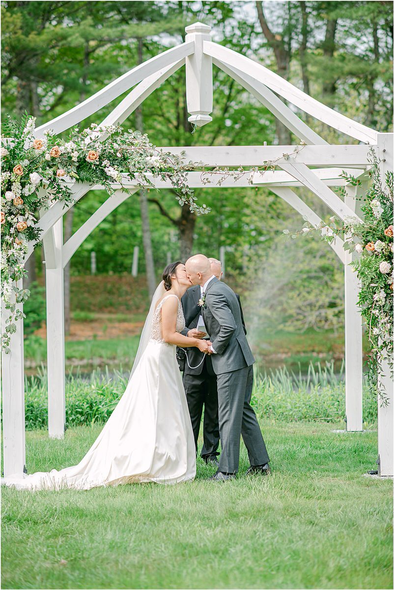 Husband and wife share their first kiss for wedding at The 1812 Farm
