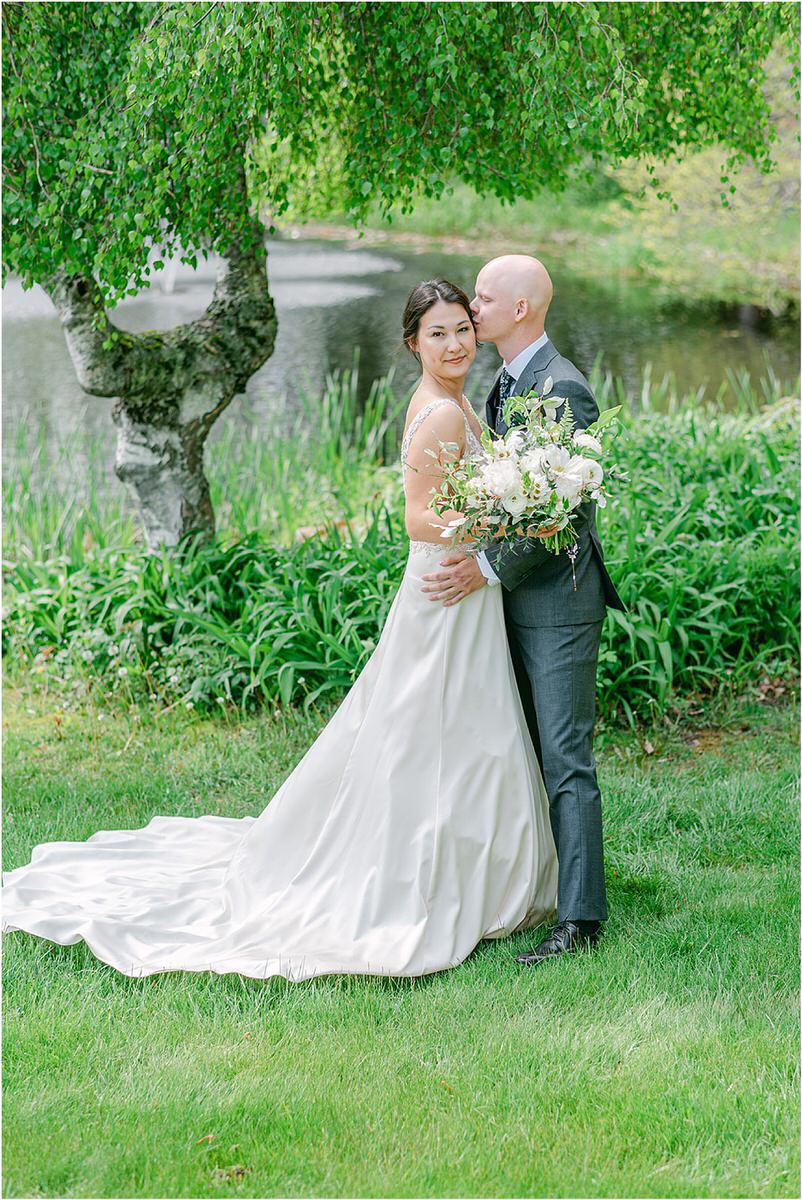 Bride and groom share a kiss for New England Wedding Photographer
