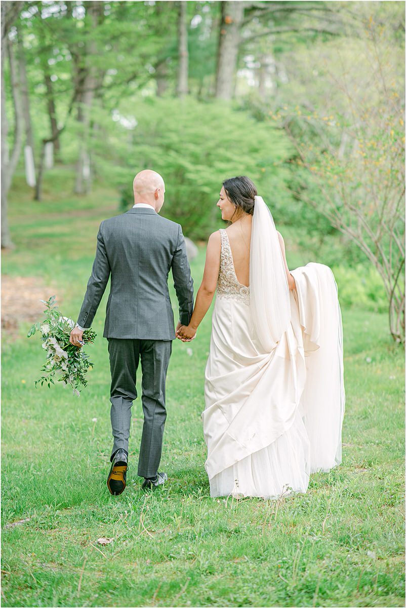 Couple walk together hand in hand for New England Wedding Photographer
