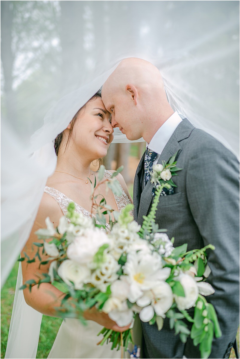 Bride and groom cuddle in close together for New England Wedding Photographer