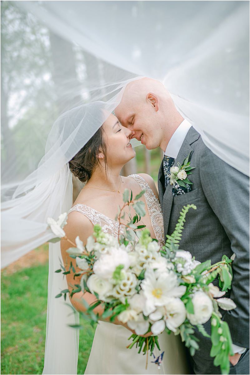 Couple smile and share a kiss for New England Wedding Photographer