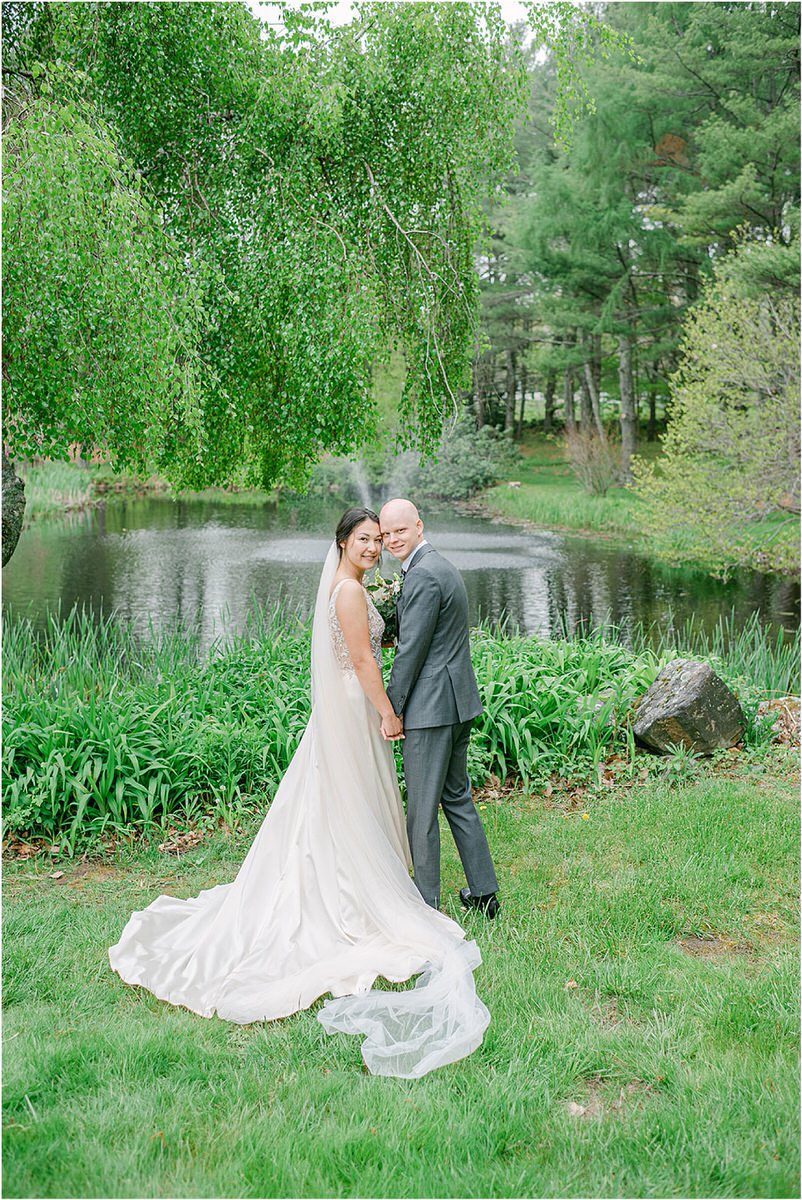 Bride and groom smile and hold each other close together for New England Wedding Photographer
