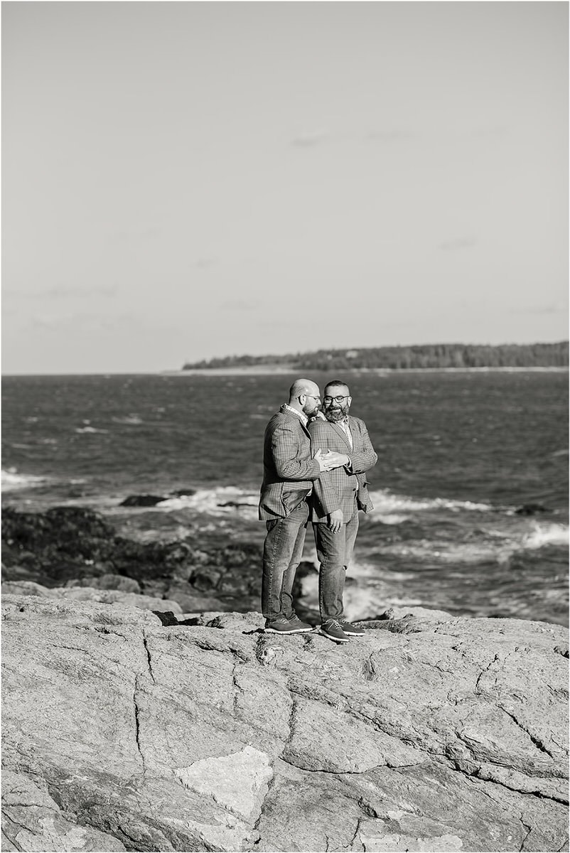 Couple hold each other before their Maine fall elopement