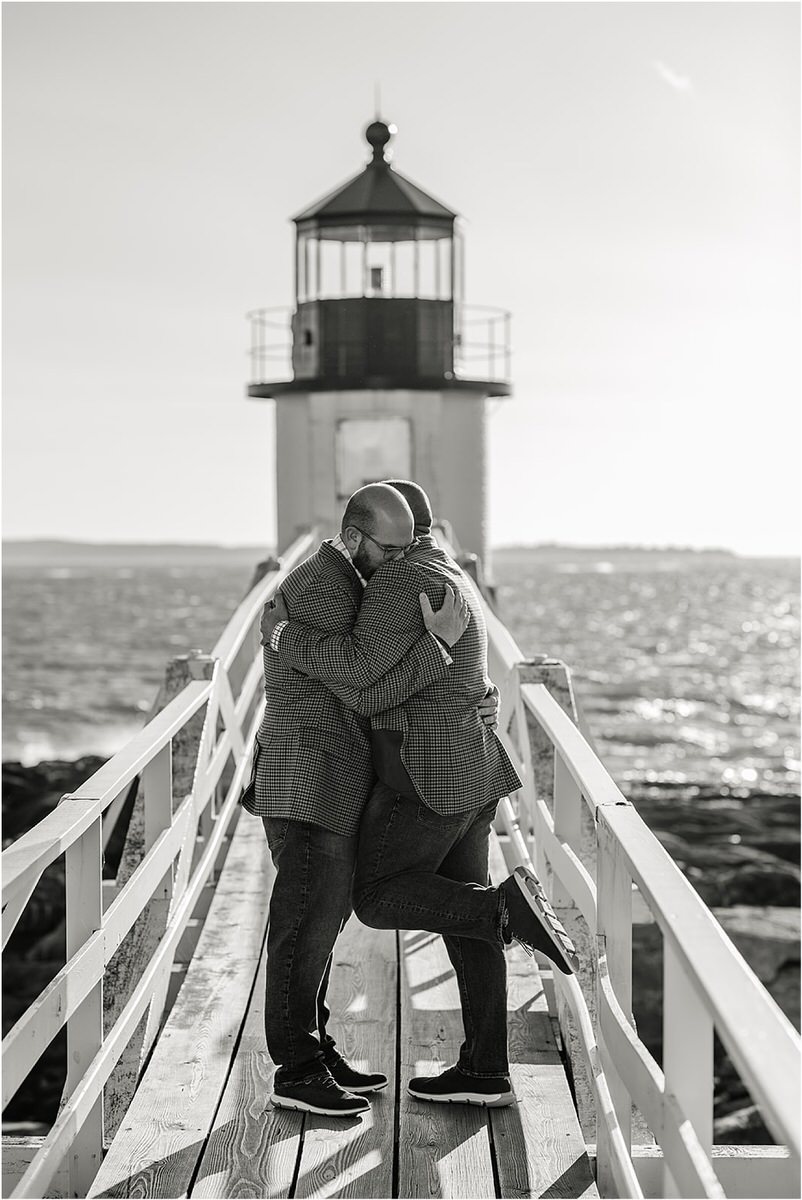 Two men share a hug before their Maine fall elopement