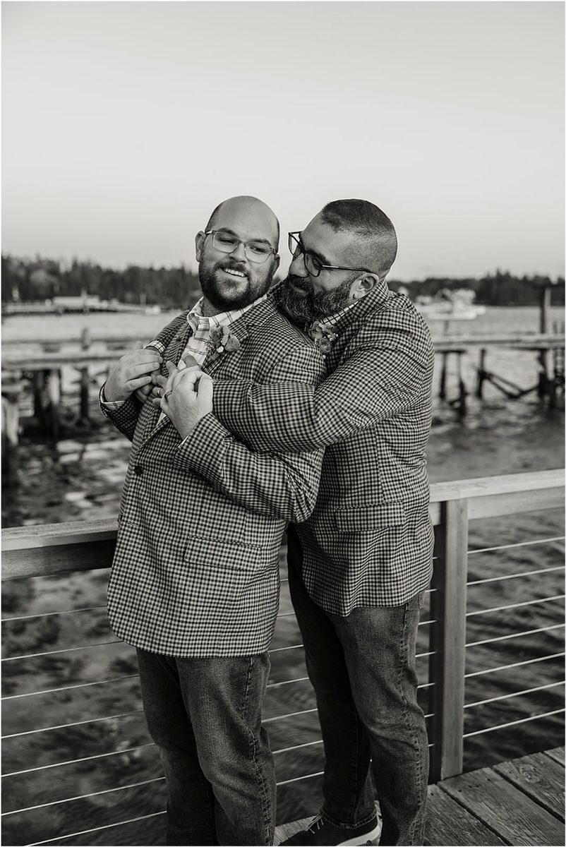 Tow men hug each other before their Maine fall elopement