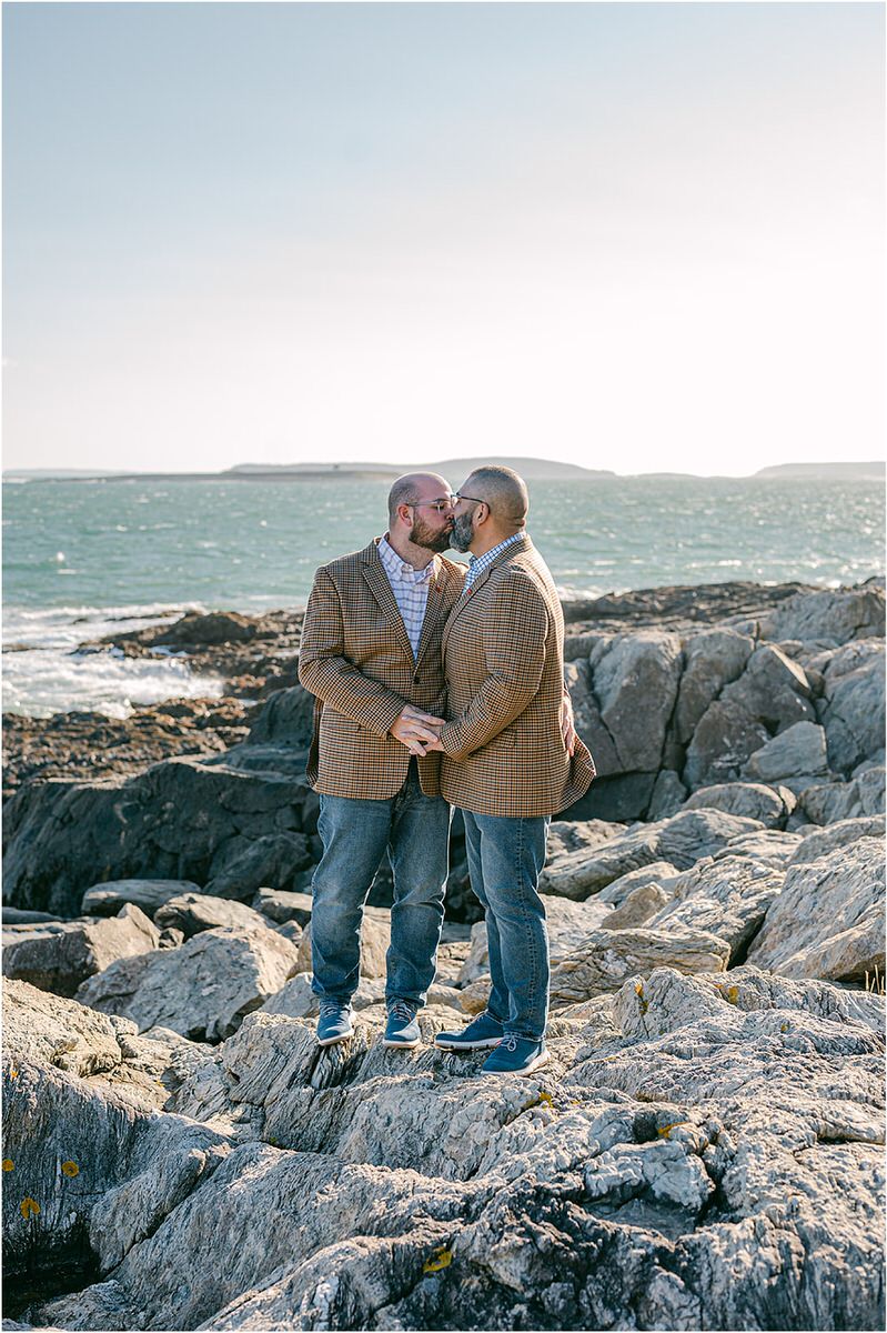 Two men share a kiss before their Maine fall elopement