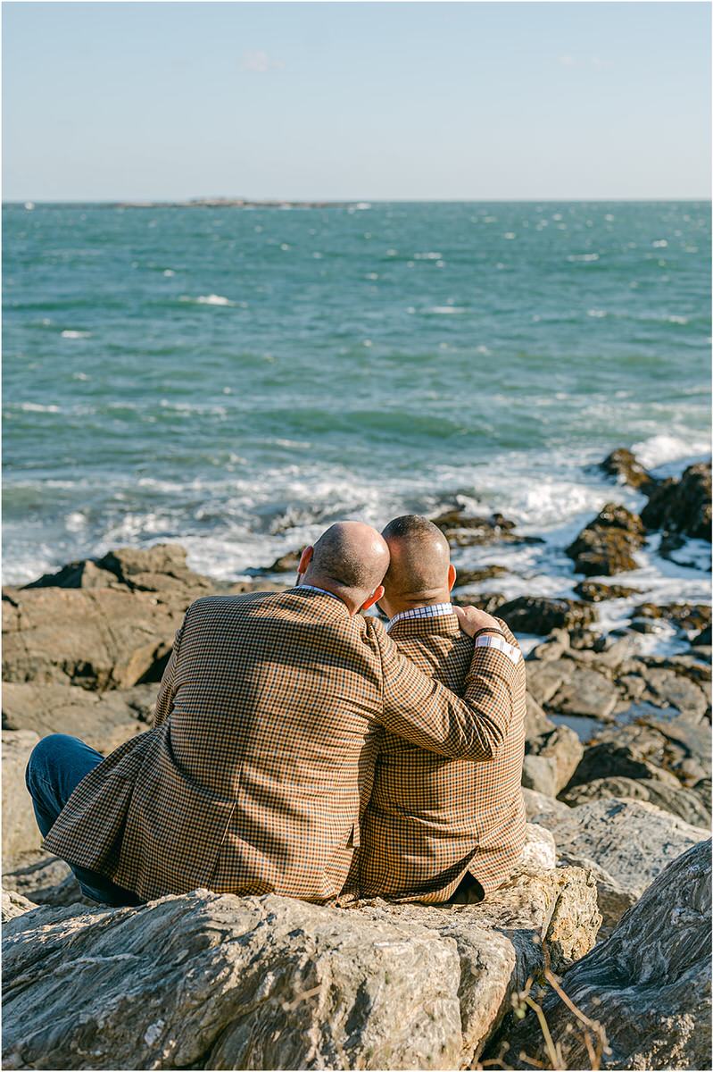 Couple look onto the water before their Maine fall elopement