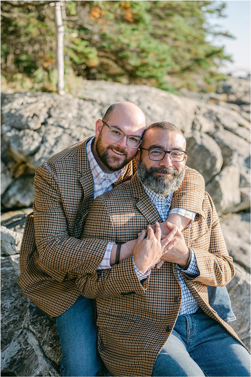 Couple hold each other before their Maine fall elopement