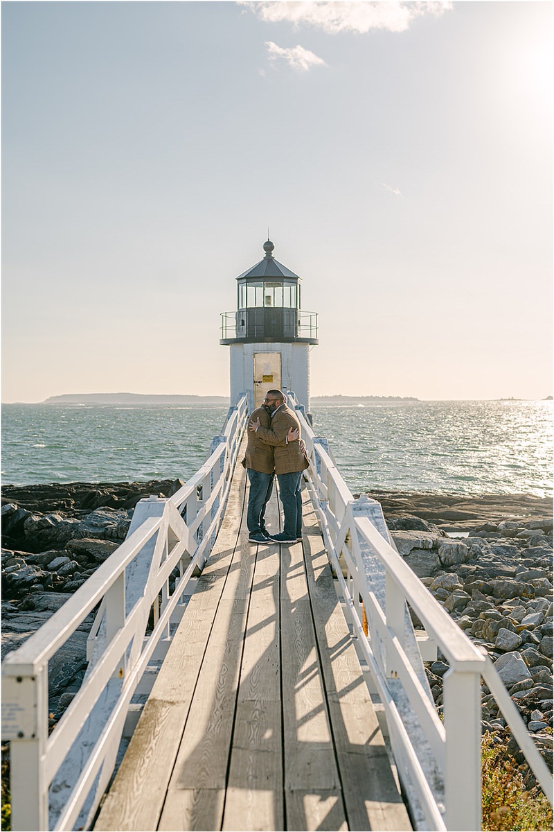 Couple hug each other before their Maine fall elopement
