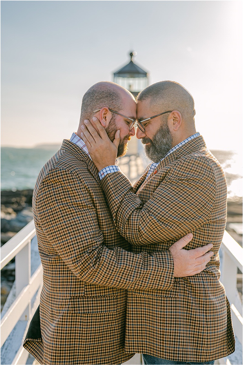 Two people hold each other close before their Maine fall elopement
