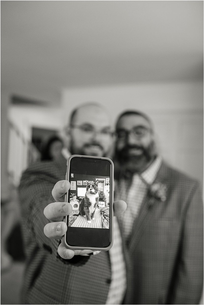 Happy couple show off their cat for Rachel Campbell Photography