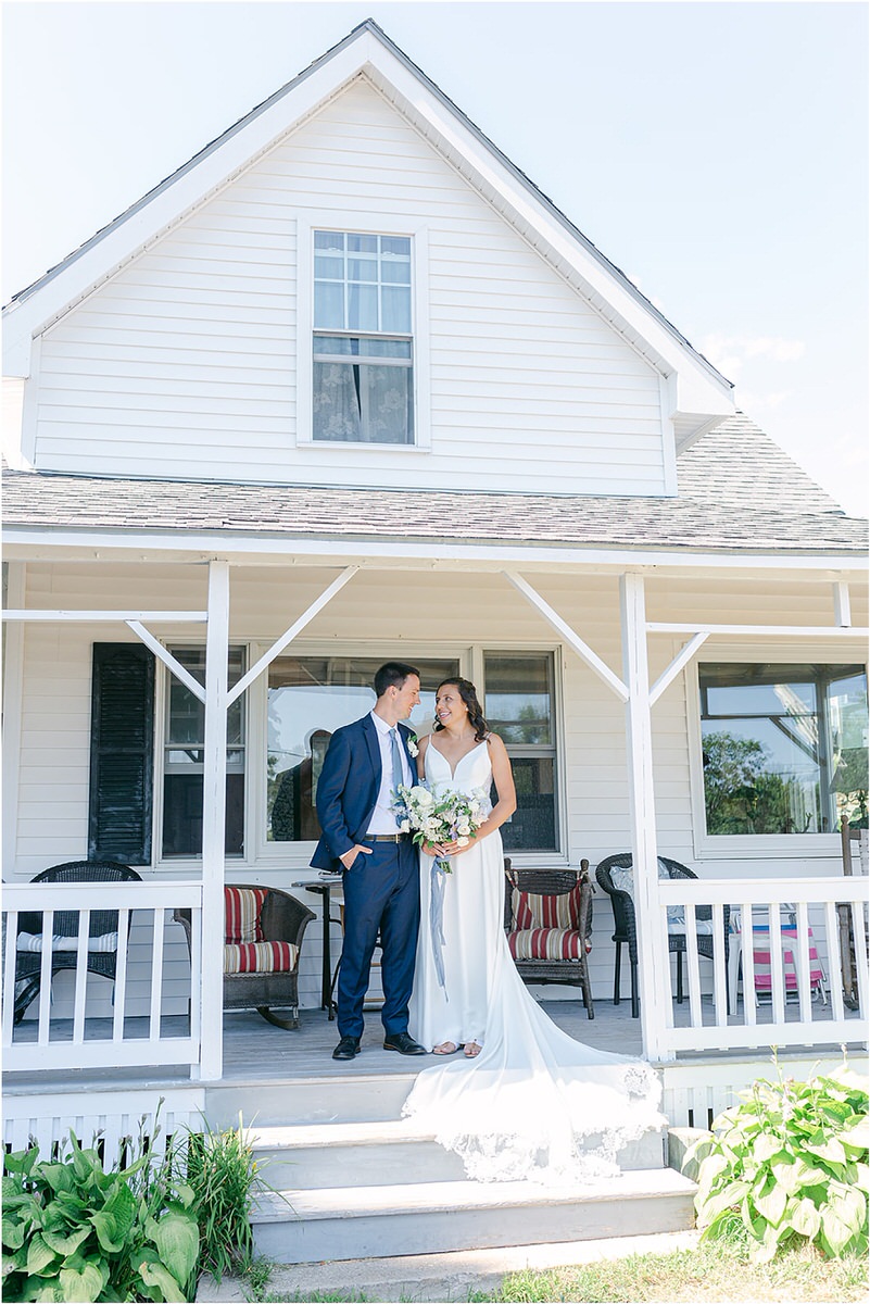 Husband and wife cuddle in close together for wedding at Portland's Ocean Gateway
