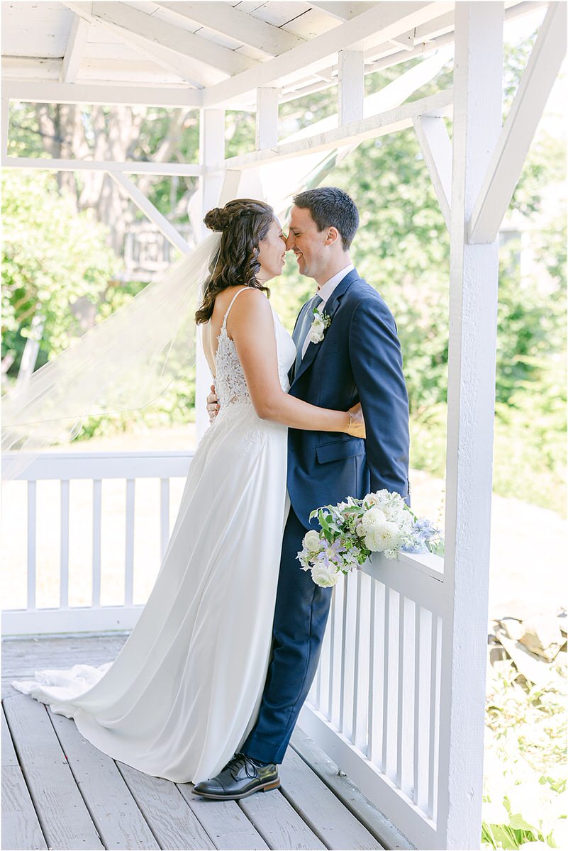 Husband and wife cuddle in close together at Portland's Ocean Gateway